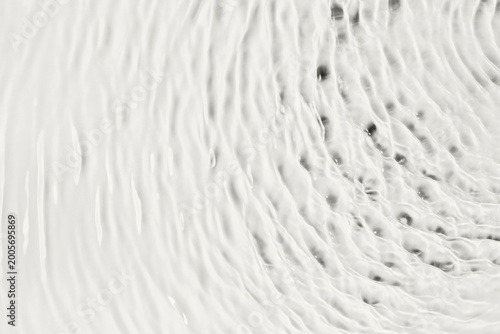 Clear water surface forming abstract waves and ripples as calm background