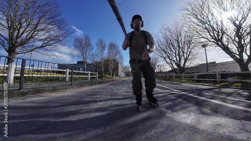 athletic man rollerblading on urban road with action camera capturing fast skating movement and outdoor fitness energy, adrenaline extreme sport