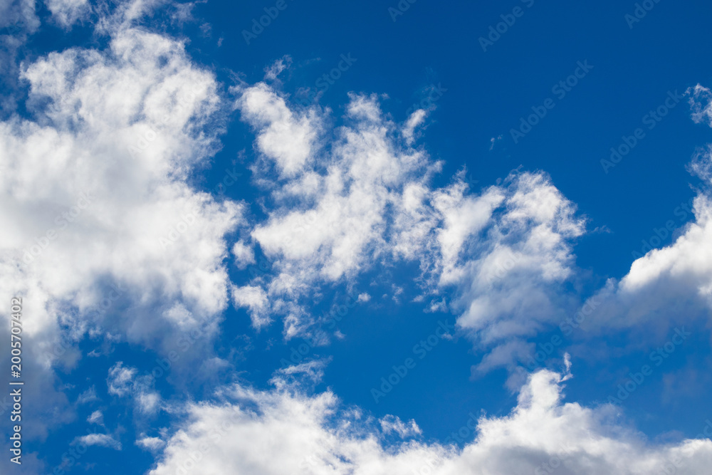 Obraz premium Beautiful blue sky with white fluffy clouds, natural daytime image, cloudscape with copy space. Scenic beauty of nature of Leh, Ladakh, India. Ladakh is known for clear atmosphere, bright environment.