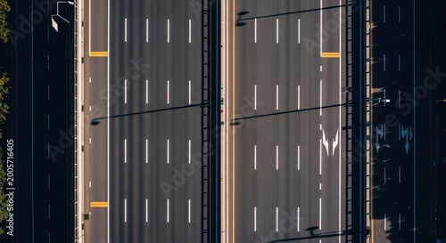 Aerial view of a multilane highway with white lane markings and minimal traffic.