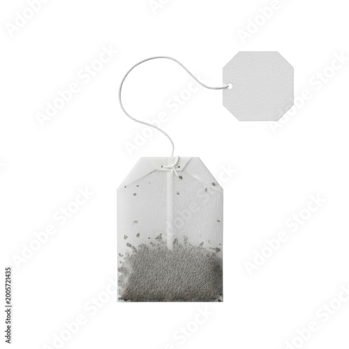Single rectangular mesh tea bag with black leaves and white string on a transparent surface in a minimalist flat lay studio concept of premium quality