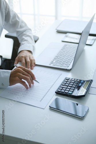 Auditor reading a report documents in office