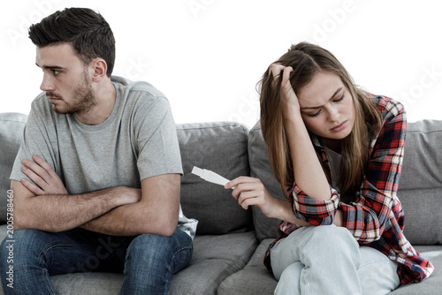 Girl having learnt she is pregnant and showing test results to boyfriend who is upset, both not knowing what to do