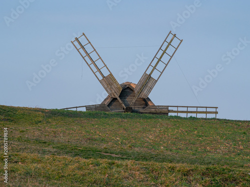 Εκτύπωση καμβά Outstretched sails of a historic windmill crowning a hilltop