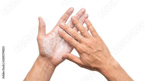 Person applying white moisturizing cream or lotion to palms