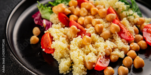Couscous with chickpeas and vegetables couscous salad main course lunch or dinner tasty snack fresh, delicious, gourmet food background on the table rustic food top view copy space 