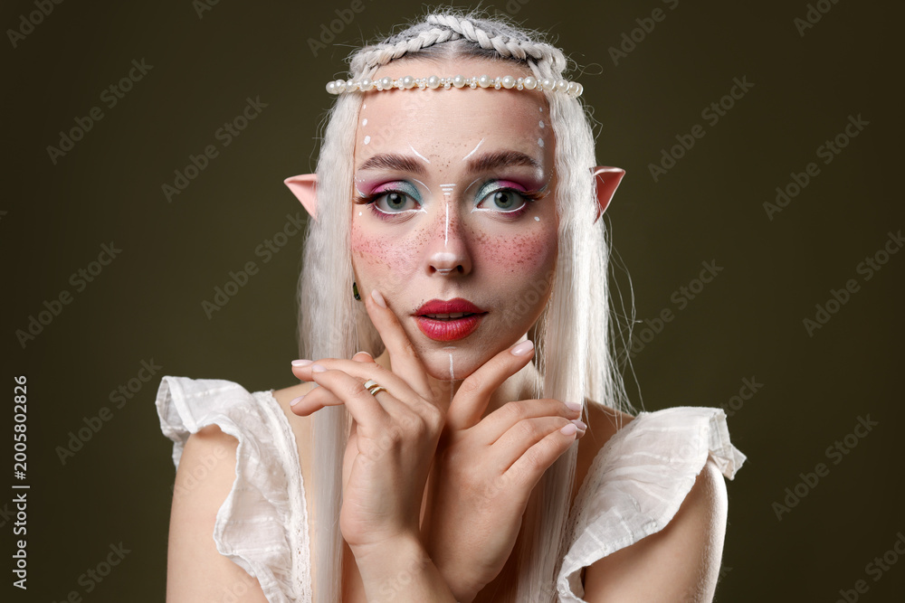 Obraz premium Beautiful elf girl on dark olive background