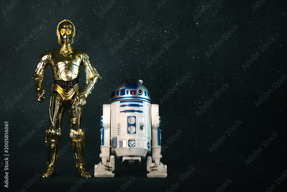 Obraz premium C3PO and R2D2 action figures characters from the Star Wars movie saga and space for text. Illustrative editorial