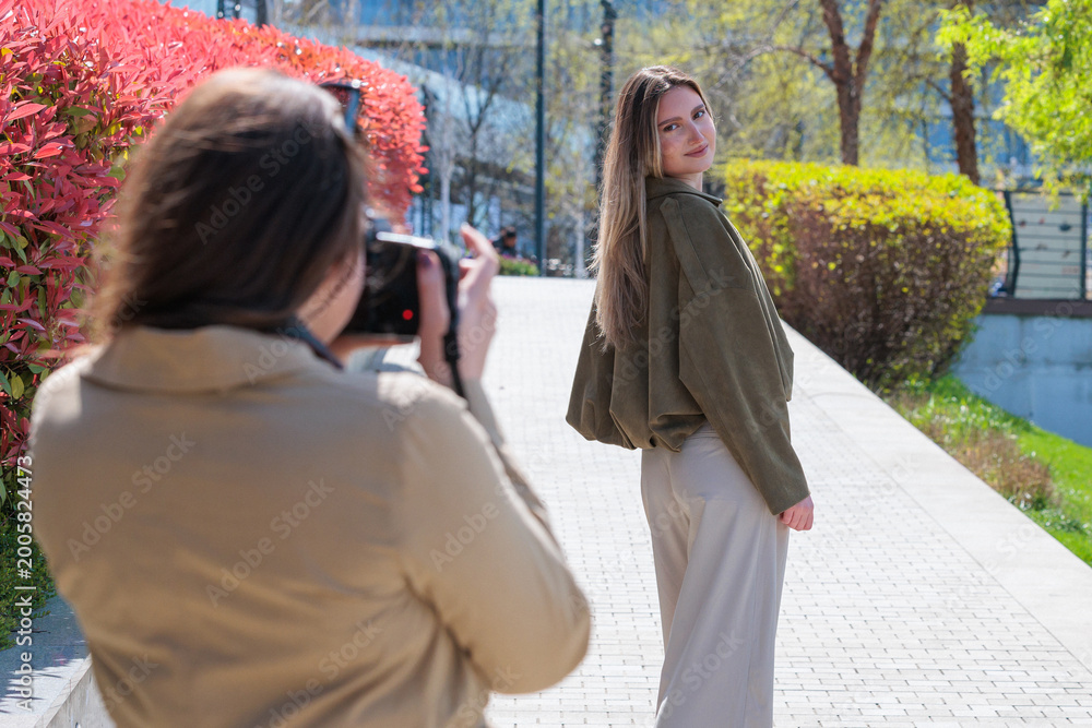 Fototapeta premium Young model photographed by female photographer in the city
