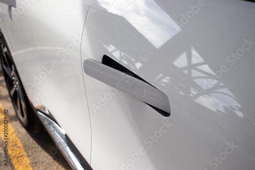 Recessed car door handles with a modern close-up design and automotive finish.