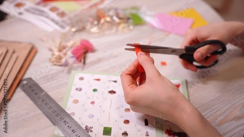 Close-up of female hands opening a bag of beads and details to create handmade jewelry. Craftswoman creating unique custom accessories in creative workshop. Handcrafted DIY jewelry artwork concept.