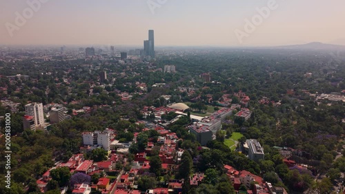 Aerial shot of south Mexico City skyline with smog and traffic