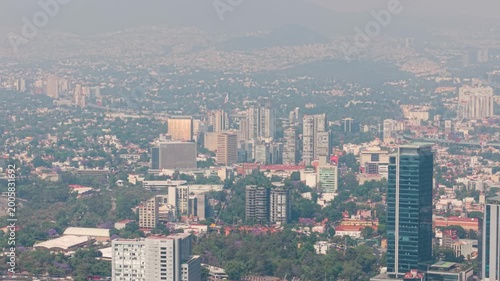 Aerial shot of south Mexico City skyline with smog and traffic