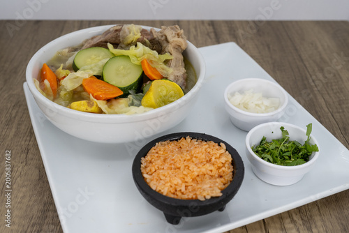 Hearty bowl of beef soup loaded with chopped vegetables, rice, and beans to satisfy that urge for a Mexican food meal