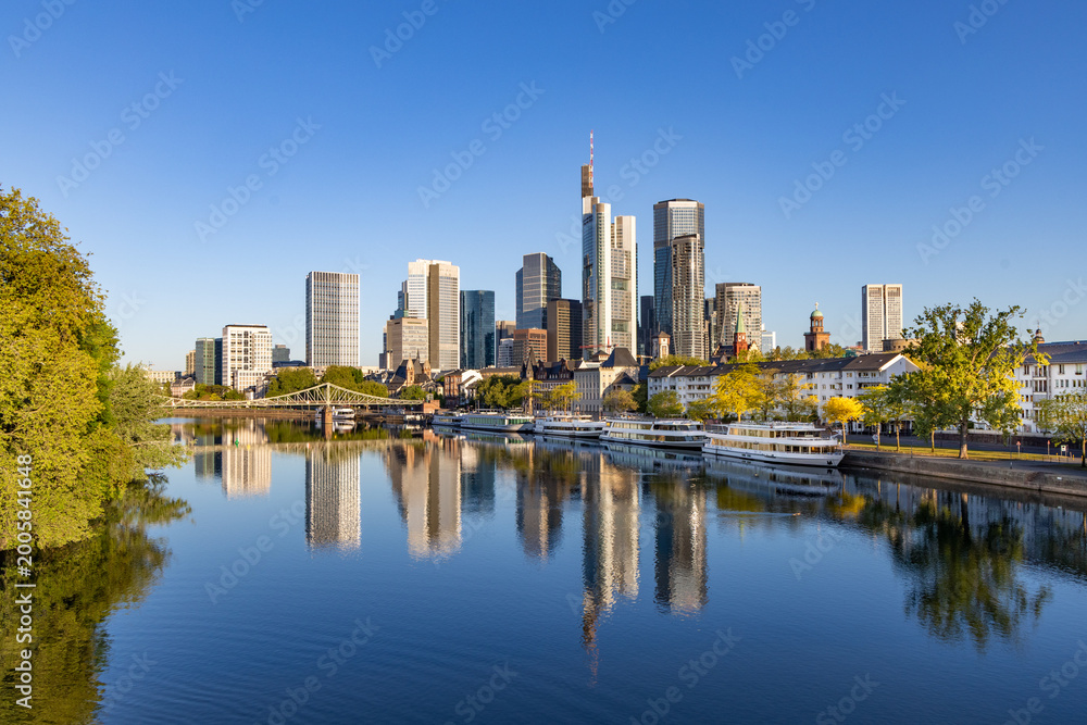 Fototapeta premium view to Frankfurt skyline with reflection of skyscraper in River Main