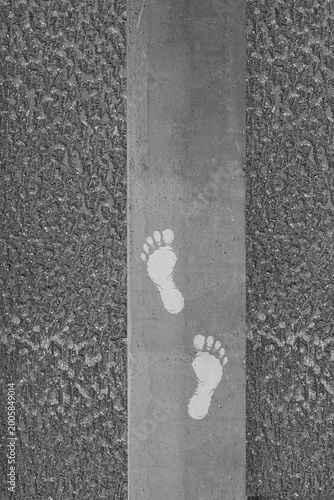 A minimalist footprint pattern on a concrete urban surface