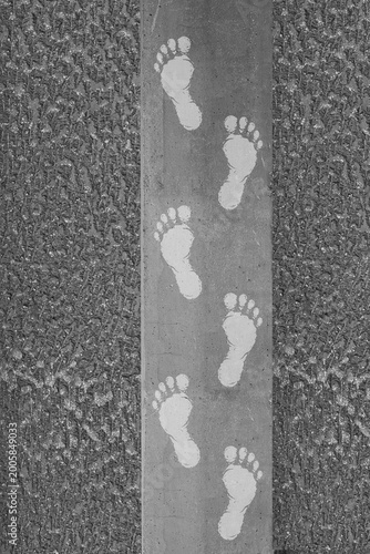 Minimalist walking footprint pattern on urban concrete texture