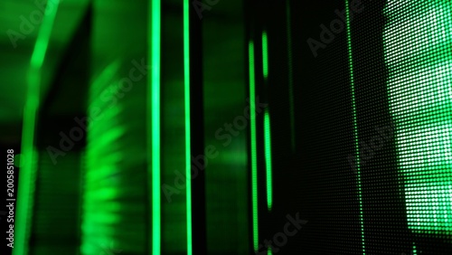 Glowing green digital display and light streaks on dark background