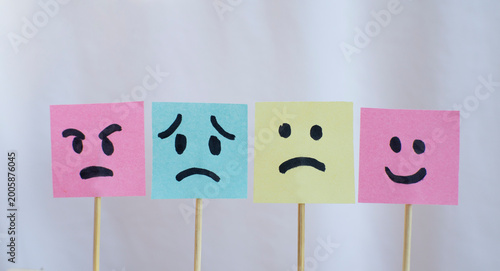 Tableau sur toile Different emotional faces on colorful sticky notes with white background