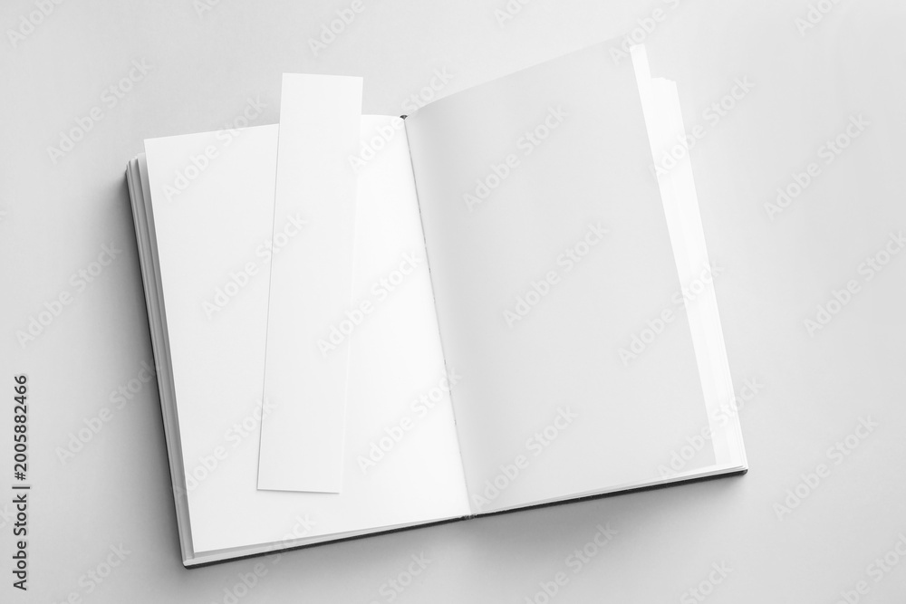 Naklejka premium Book with white bookmark on grey background, top view. Space for text