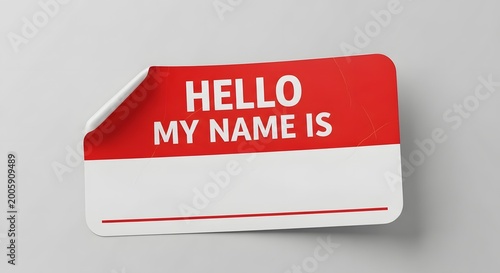 A classic red and white Hello My Name Is sticker with blank space floating on a light gray surface