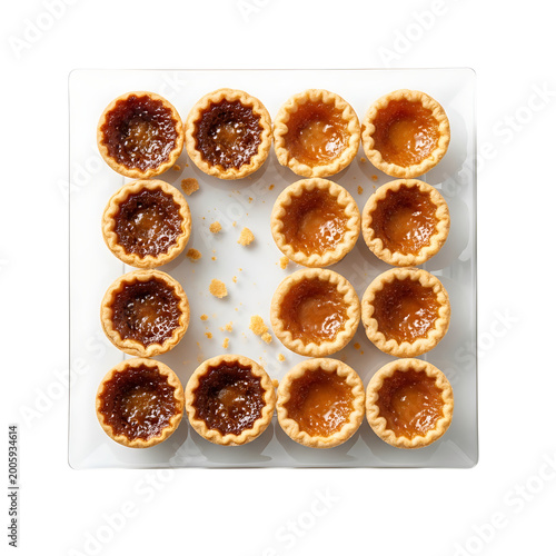 Homemade butter tarts on glass plate