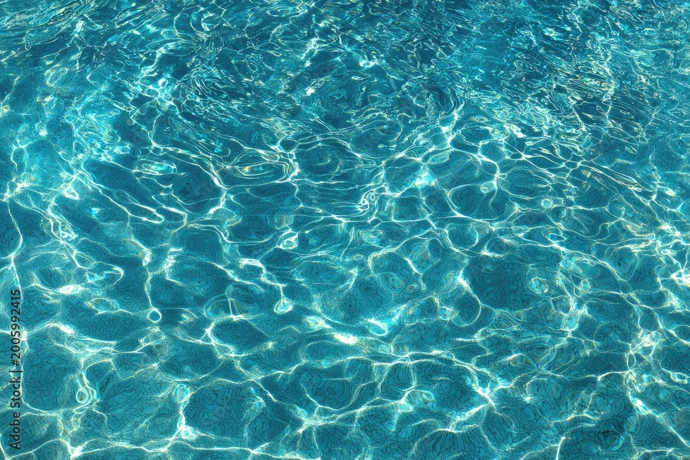 Fototapeta premium Rippling turquoise water, dappled sunlight creating shimmering patterns on surface