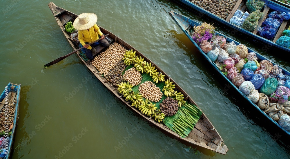Obraz premium Busy floating market with vendor in boat selling produce