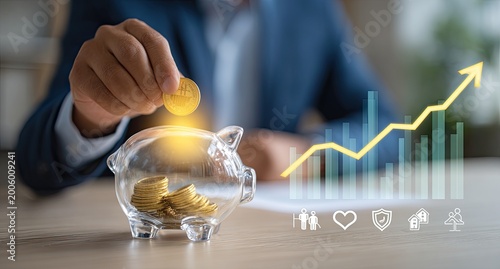 Person drops coin into piggy bank with rising financial graph
