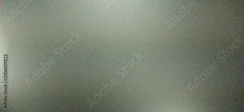 Schilderij op canvas A dark, out-of-focus abstract background with significant digital noise, showing a soft diagonal light grey glow against a deep charcoal base