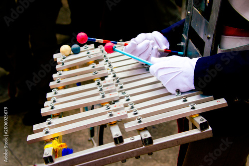 Marching band glockenspiel performance in outdoor parade with natural light