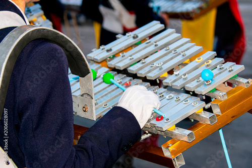 Marching band glockenspiel performance in outdoor parade with natural light