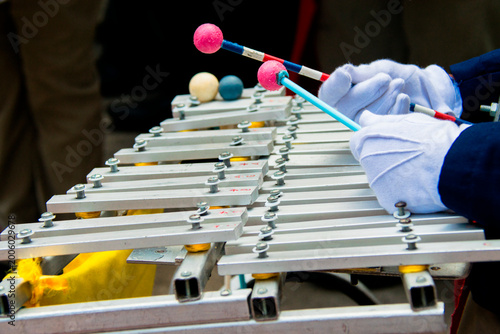 Marching band glockenspiel performance in outdoor parade with natural light