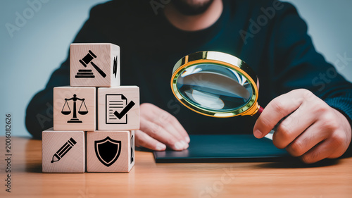 Businessperson holding wooden blocks with representing law justice finance and security