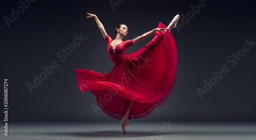 Elegant Ballerina in a Flowing Red Dress Performing a Graceful Dance.