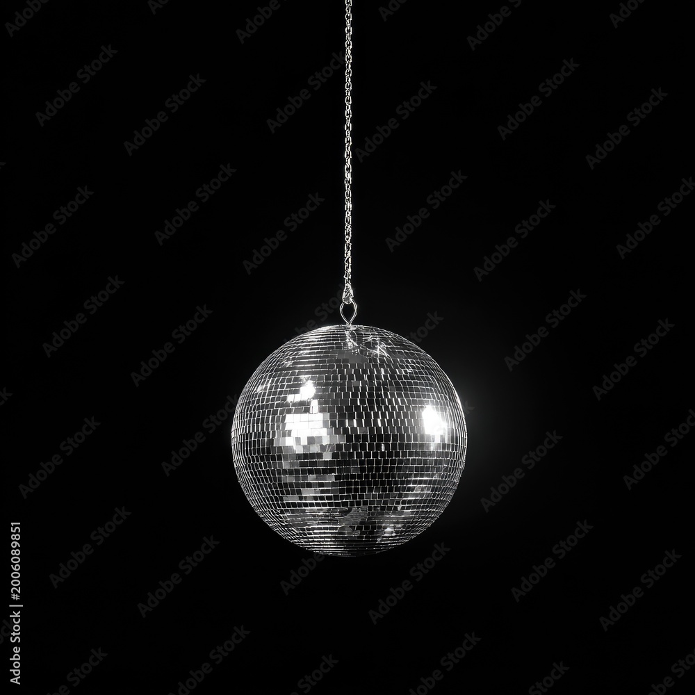 Obraz premium Glittering orb hangs from silver chain against a stark black background
