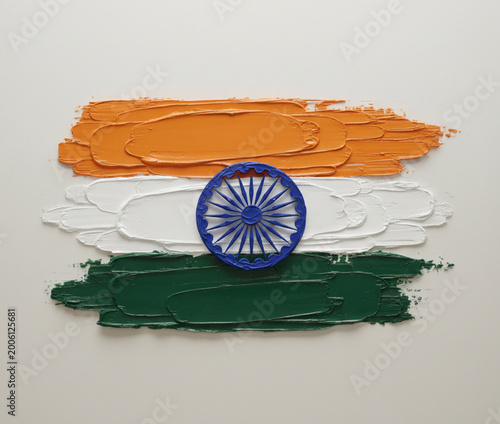 Indian National Flag featuring vibrant orange leaves, white leaves, and green leaves. Centered is a navy blue Ashoka Chakra. (2)