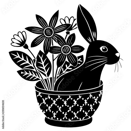 Black and white rabbit sitting in a floral pot