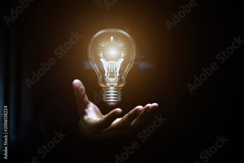 Hand chooses light bulb or lamp icons with business growth icons for human resources or leadership and creativity thinking idea motivation or vision and knowledge learning.