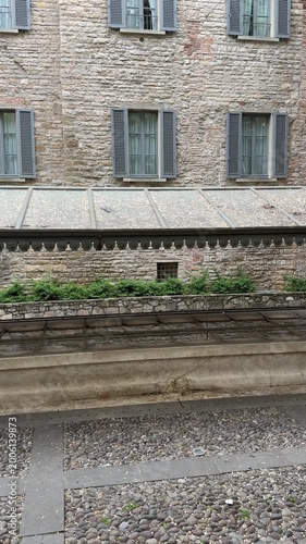 Bergamo, Italy. The old washhouse at the old town. A long white marble basin, subdivided into several parts, with a cast-iron cover and sheet metal plates