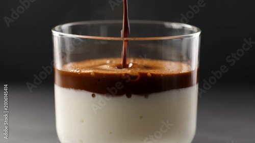 Espresso coffee with crema layer forming in glass cup rich texture extreme close up minimal shot