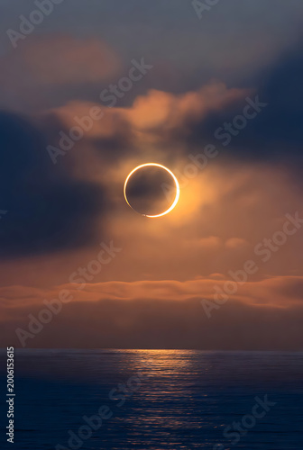 A rare solar eclipse glowing beautifully above a calm ocean horizon.