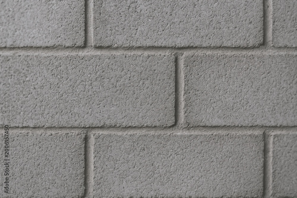 Fototapeta premium Close up of a gray concrete cinder block wall with textured surface and mortar lines