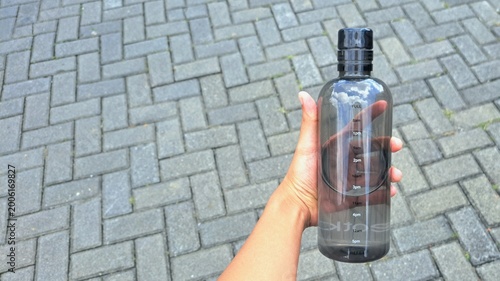 Hand Holding Water Bottle with Time Marker Hydration and Healthy Lifestyle