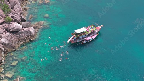 Aerial Top Down View of Tourists Snorkeling Around Boat Ko Nang Yuan Thailand