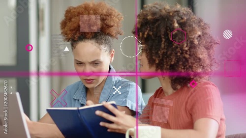 Two women right holding notebook urging left tapping laptop pink overlays sweeping for study