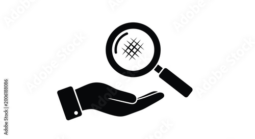 Photos A black silhouette of a hand holding a magnifying glass over a grid pattern