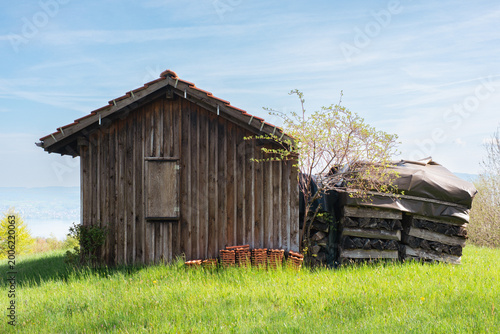 old wooden barn in green field