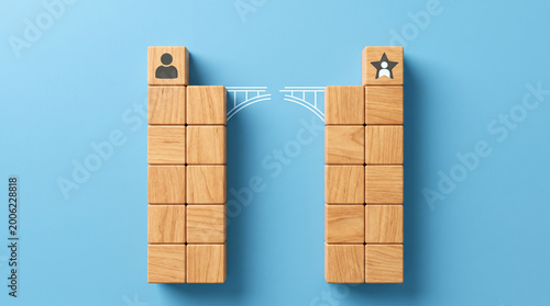 Two wooden cube towers with a gap between them and a bridge-building icon on a clean sky-blue background for skill gap analysis and workforce upskilling.