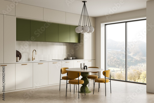 Obraz na plátně Modern minimalist kitchen interior with green cabinets, round dining table, mustard chairs, expansive window view and warm natural lighting